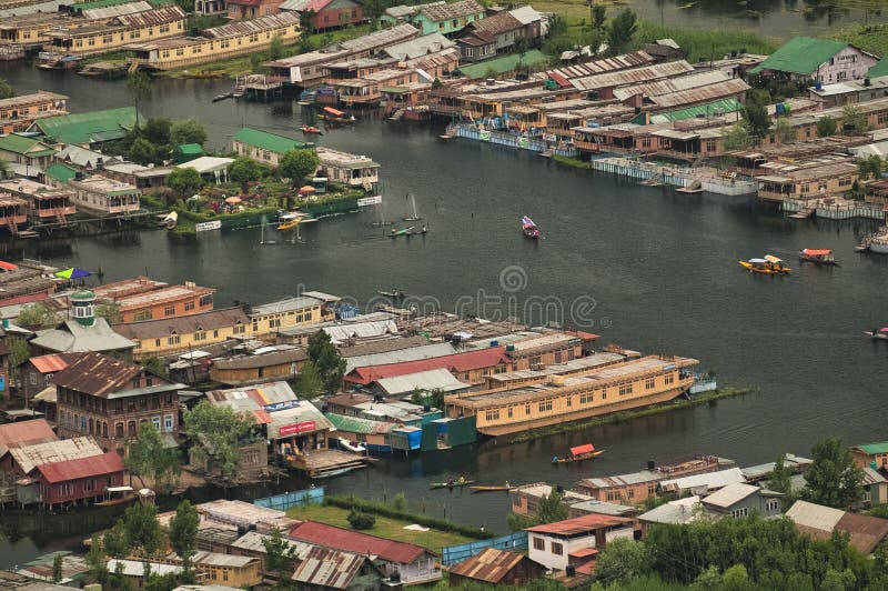 Top view of congested houseboats, shikara, boats, and houses in blue waters of Dal Lake. Jammu and Kashmir, India