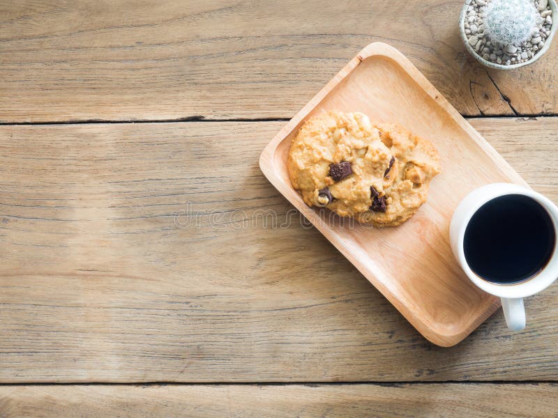 Top view of cookies with chocolate and macadamia nuts. Placed on a wooden plate.