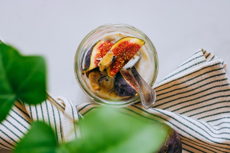 Top view Dessert of sour cream, vanilla, figs, nuts, honey and blue cheese in a glass on a marble stock photography Top view Dessert of sour cream, vanilla, figs, nuts, honey and blue cheese in a glass on a marble stock photography