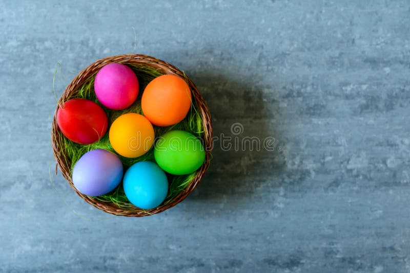 Top View of Easter Eggs in a Basket on Concrete Background Stock Photo