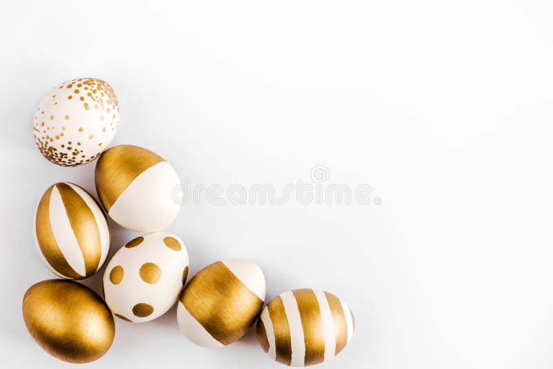 Top view of easter eggs colored with golden paint. Various striped and dotted designs. White background. stock image Top view of easter eggs colored with golden paint. Various striped and dotted designs. White background. stock image
