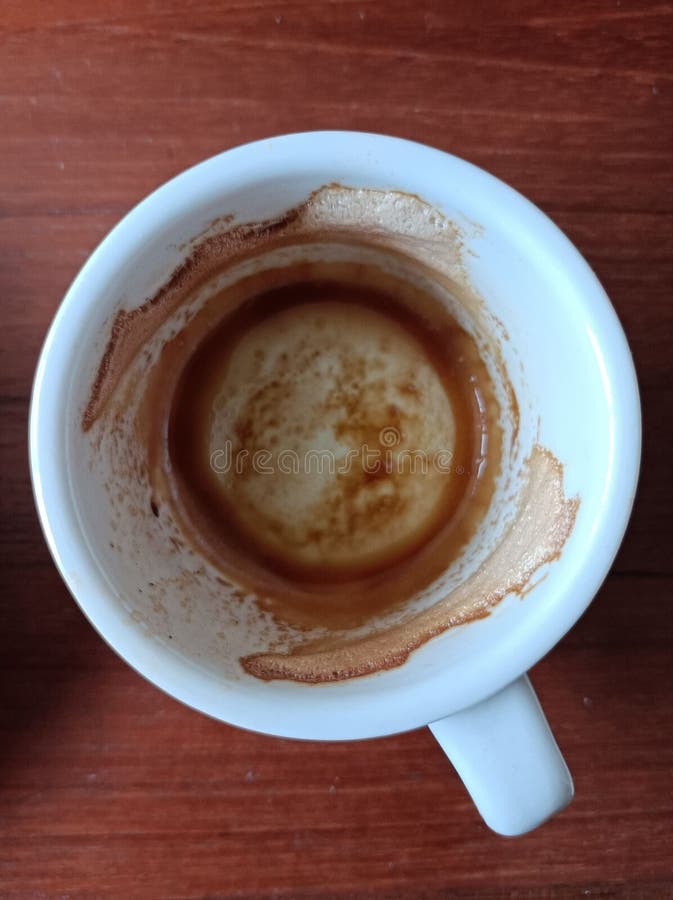 Top View of the Espresso Coffee Grounds in the Cup Put on the Wooden