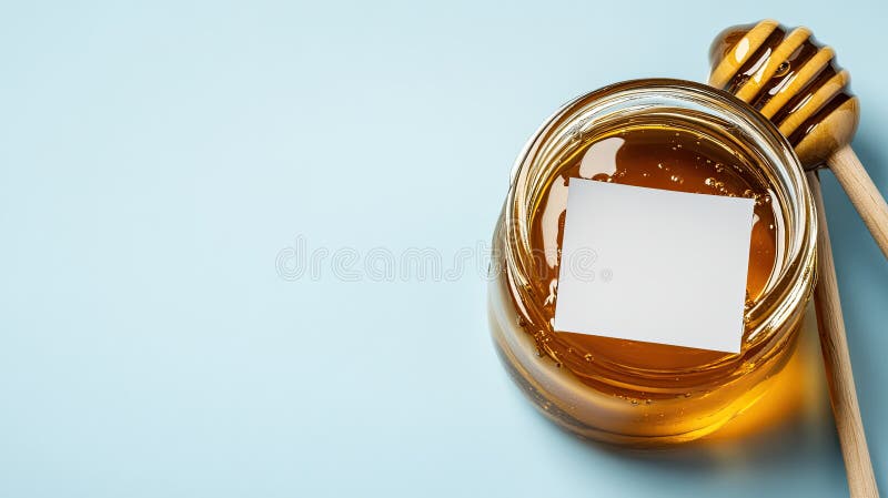 Top view of five clear jars filled with golden honey, inviting creativity with blank labels on a soft light blue royalty free stock photo