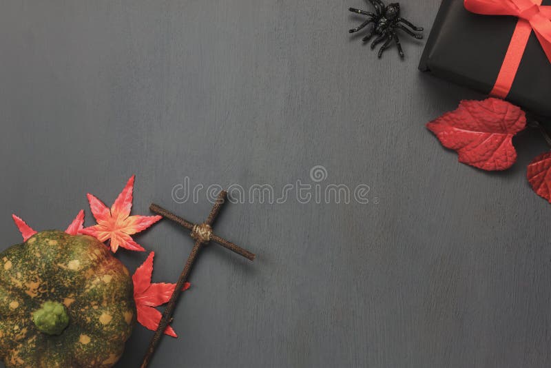 Top view / Flat lay Halloween `s pumpkin and accessories or items the leaf spider and gift / present on rustic wooden background. royalty free stock photos