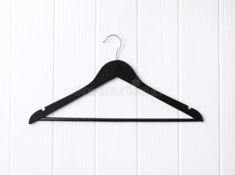 Top View Flat Lay Single Black Wooden Hanger At Wooden Background