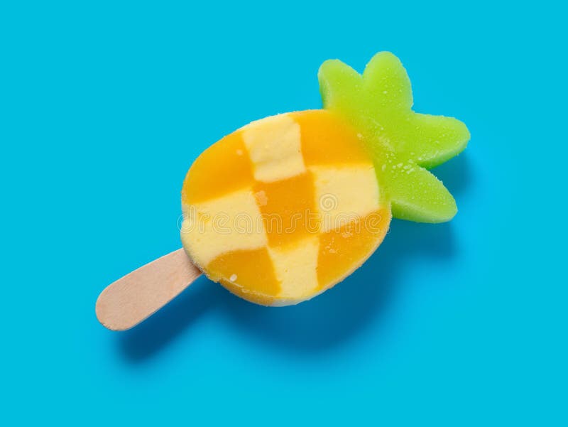 Top view fresh pineapple shape popsicle on blue background