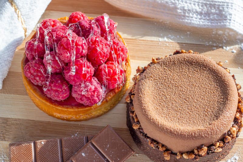 Top view of fresh raspberry and chocolate tarts on the kitchen table background close up. stock images Top view of fresh raspberry and chocolate tarts on the kitchen table background close up. stock images