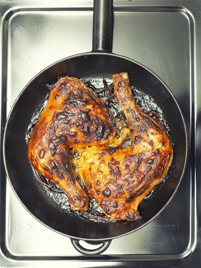 Top View of Fried, Chicken Drumsticks on Cast Iron Pan Stock Photo