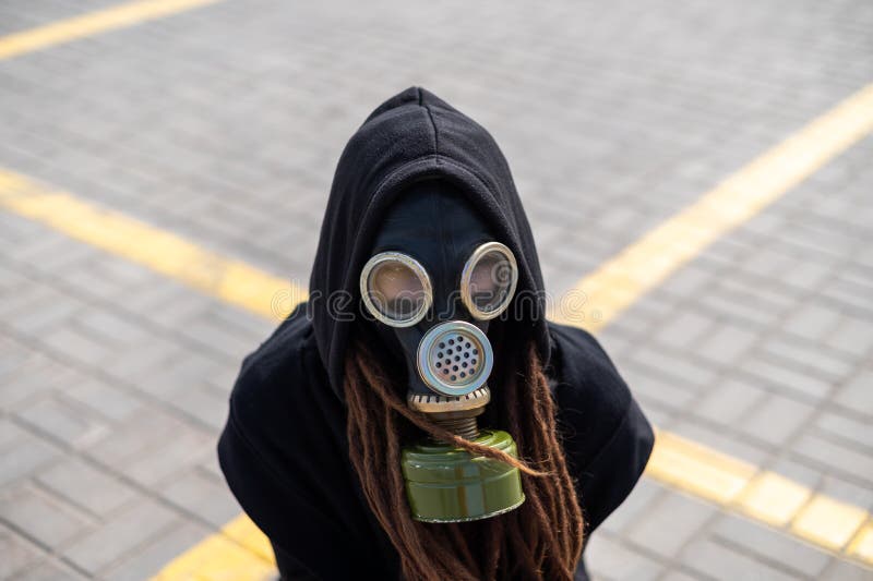 Top view of a girl with dreadlocks in a gas mask and a black hood. Respiratory protection. contaminated air royalty free stock photography Top view of a girl with dreadlocks in a gas mask and a black hood. Respiratory protection. contaminated air royalty free stock photography