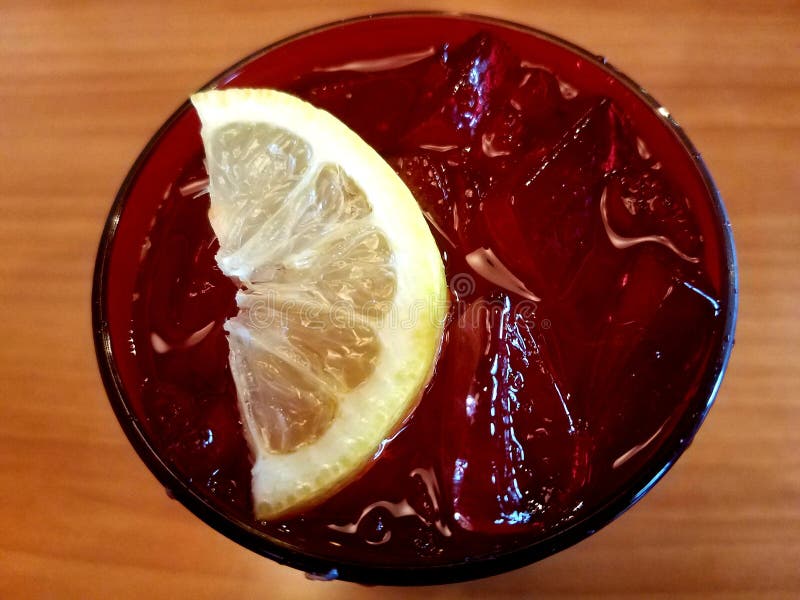 The top view of a glass of cold water with ice and a slice of lemon royalty free stock photo