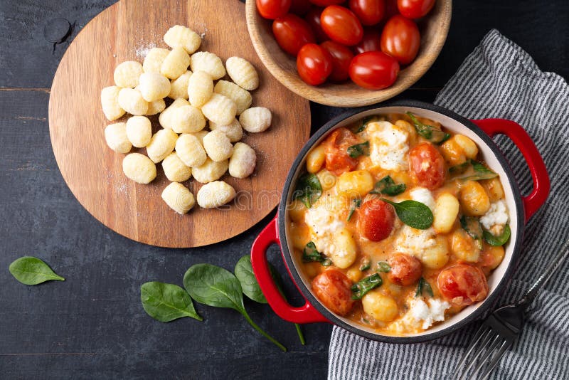 Top View of Gnocchi in Creamy Tomato Sauce with Baby Spinach and Melted