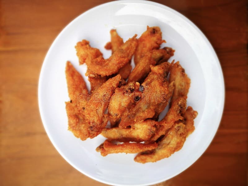 Top view of Golden brown fried chicken wings in a white plate on stock photography Top view of Golden brown fried chicken wings in a white plate on stock photography