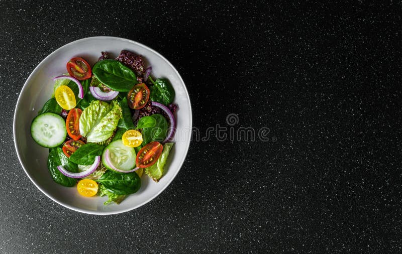 Top View of Greens Vegetable Salad Bowl with Lettuce, Spinach, and