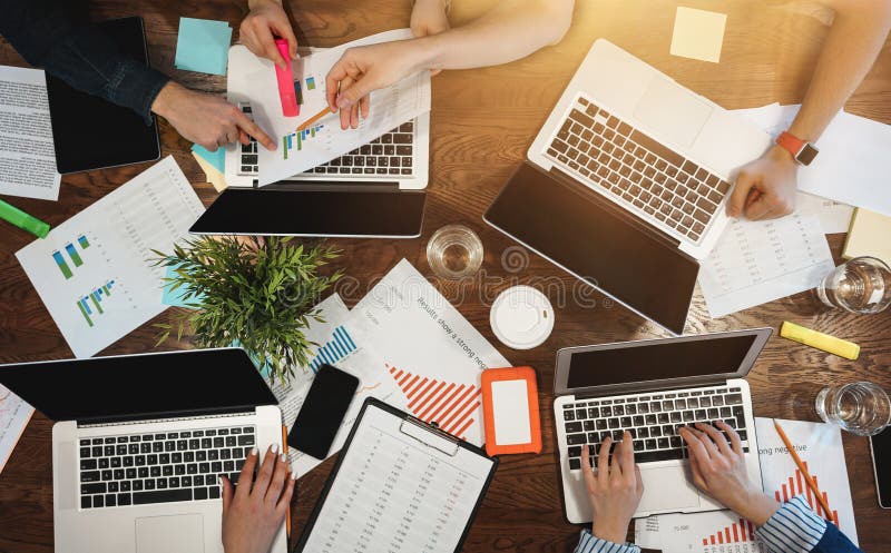 Top view of group business people sitting at table and using modern laptop, graphs and diagrams. Team of architecture are having a stock photos Top view of group business people sitting at table and using modern laptop, graphs and diagrams. Team of architecture are having a stock photos