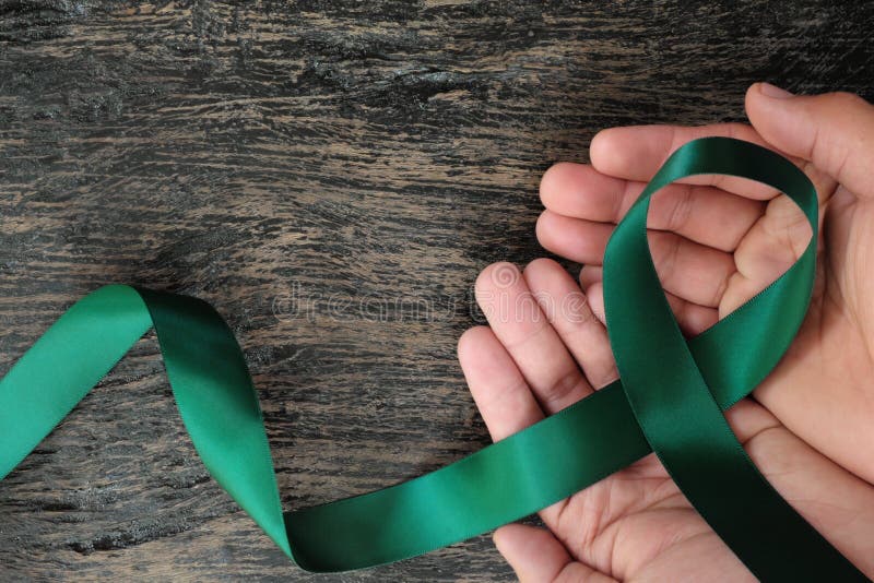 Top View Of Emerald Green Ribbon On Dark Wood Background Liver Cancer  Awareness Concept High-Res Stock Photo - Getty Images