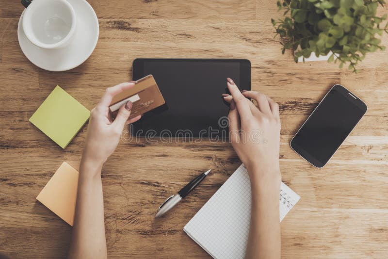 Top view of hands holding tablet table background