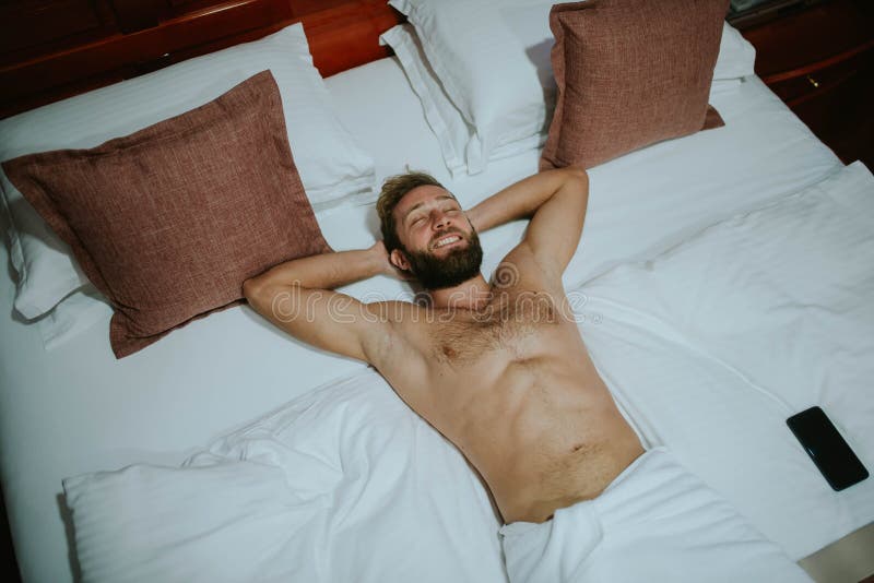 Top View of a Handsome Man Smiling while Sleeping in a Hotel Bed Stock  Image - Image of male, exhausted: 204671373