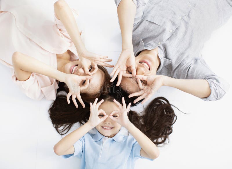 Happy asian Family lying on the floor stock image Happy asian Family lying on the floor stock image