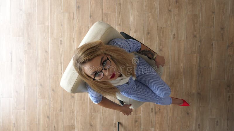 Top view happy businesswoman spinsin office chair