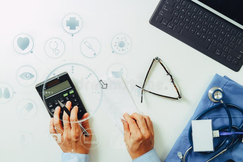 top view of Healthcare costs and fees concept.Hand of smart doctor used a calculator for medical costs in modern hospital with VR icon diagram