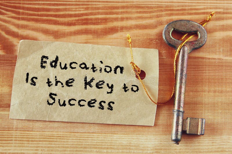 Top view image of key with note and the phrase education is the key to success.