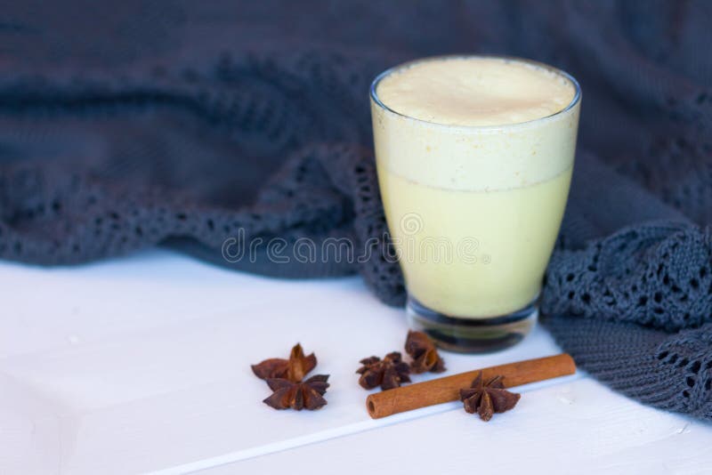 Turmeric latte and a warm blanket. the concept of comfort. warm home. Turmeric Latte with Nut Milk, cinnamon, honey, ginger royalty free stock photo Turmeric latte and a warm blanket. the concept of comfort. warm home. Turmeric Latte with Nut Milk, cinnamon, honey, ginger royalty free stock photo