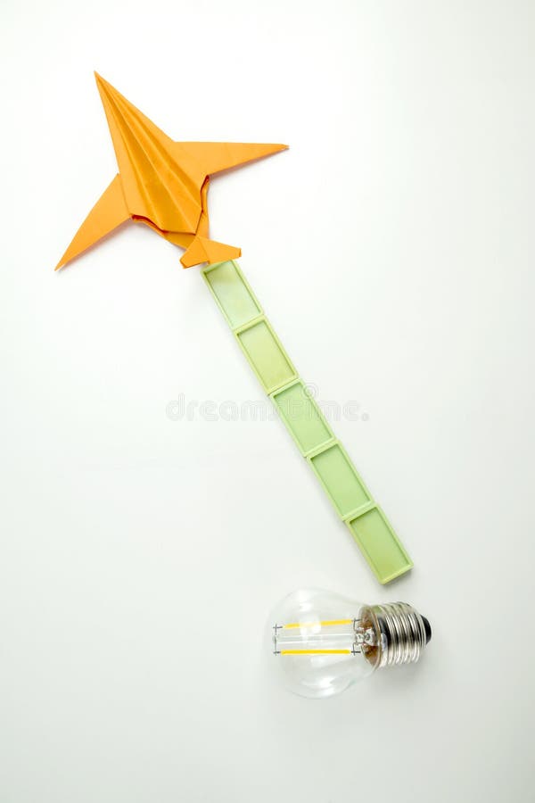 Top view of a lightbulb with rectangular blocks and paper airplane on white background concept travel exploration navigation imagem de stock royalty free