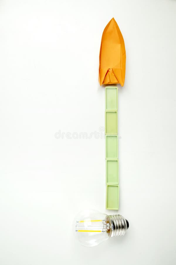 Top view of a lightbulb with rectangular blocks and paper sailboat on white background concept travel exploration navigation imagens de stock