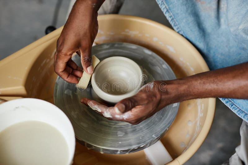 Hands of Black Young Man Using Pottery Wheel and Creating Handmade