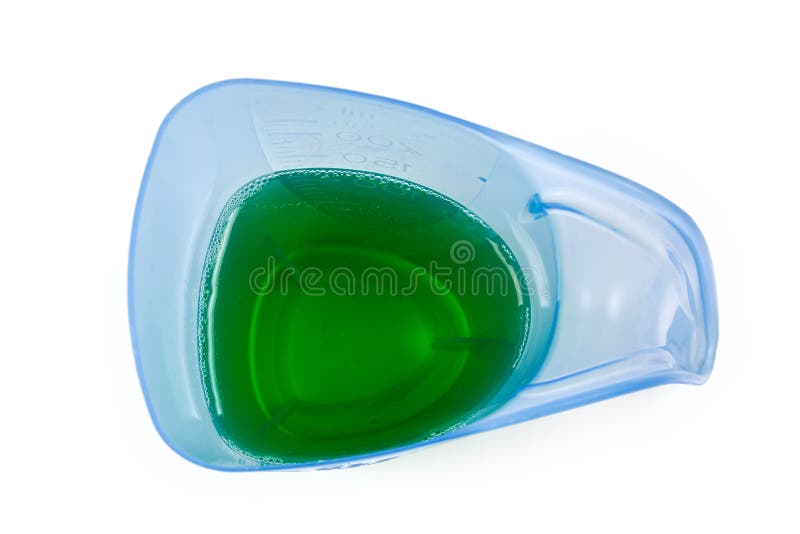 Liquid Laundry Detergent in Measuring Cup on a White Background Stock