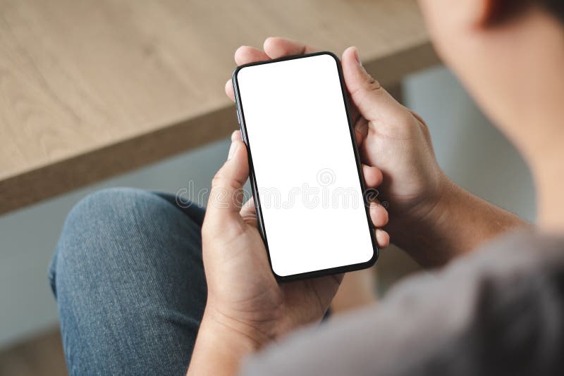 Top view Mockup image hand using a smartphone man Holding Cell Phone With Blank Screen royalty free stock image