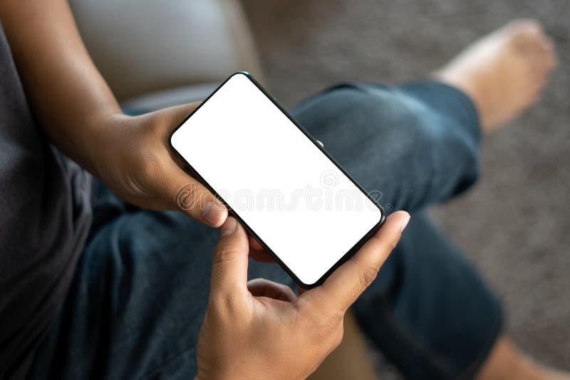 Top view Mockup image hand using a smartphone man Holding Cell Phone With Blank Screen stock image
