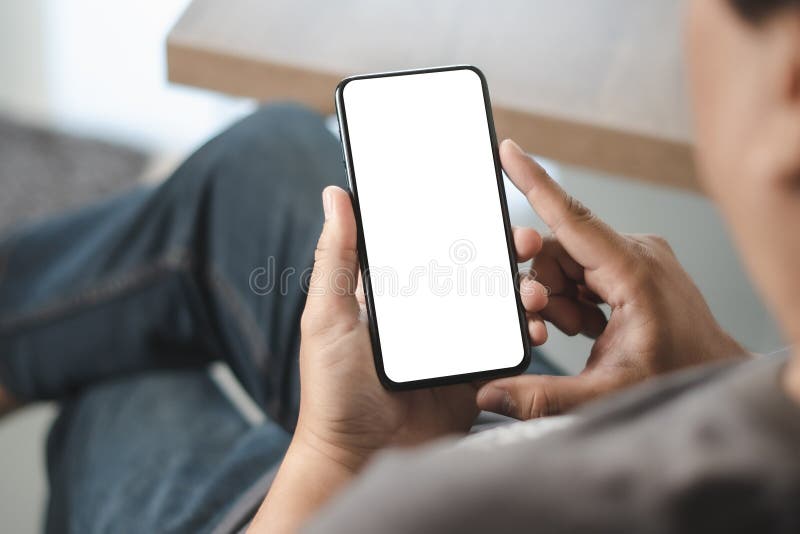 Top view Mockup image hand using a smartphone man Holding Cell Phone With Blank royalty free stock image
