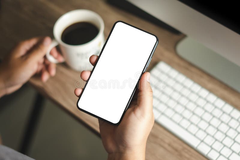 Top view Mockup image hand using a smartphone man Holding Cell Phone With Blank Screen stock image