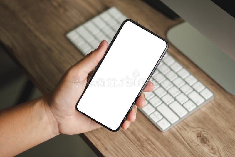 Top view Mockup image hand using a smartphone man Holding Cell Phone With Blank Screen stock image