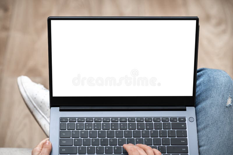 Top view mockup image of woman working and typing on laptop computer with blank screen while sitting on a sofa at home royalty free stock photo