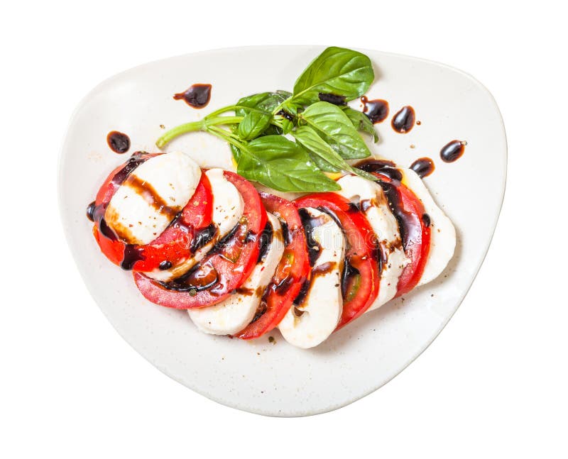 Top view of mozzarella and tomato with basil twig