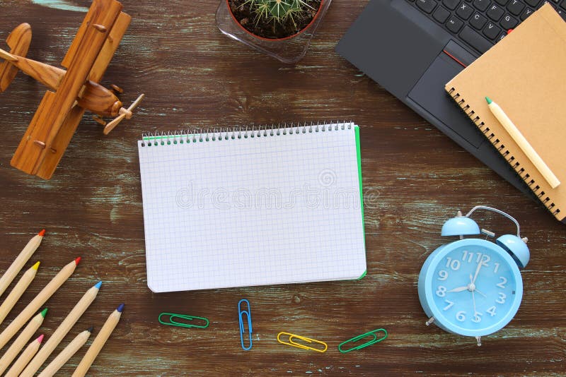 Top view of office work table with leptop and open empty notebbok stock photos Top view of office work table with leptop and open empty notebbok stock photos