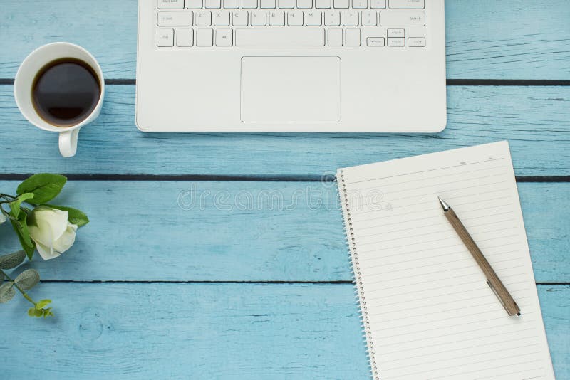 Top view of open notebook, blank notebook and coffee cup on blue wooden table background. stock photos
