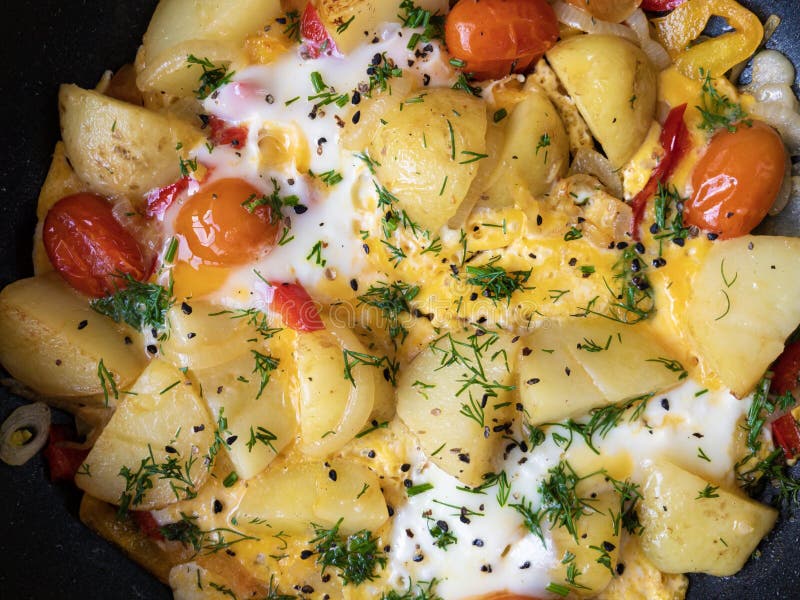 Pan Full Fried Egg and Boiled Potatoes Browned with Vegetables and