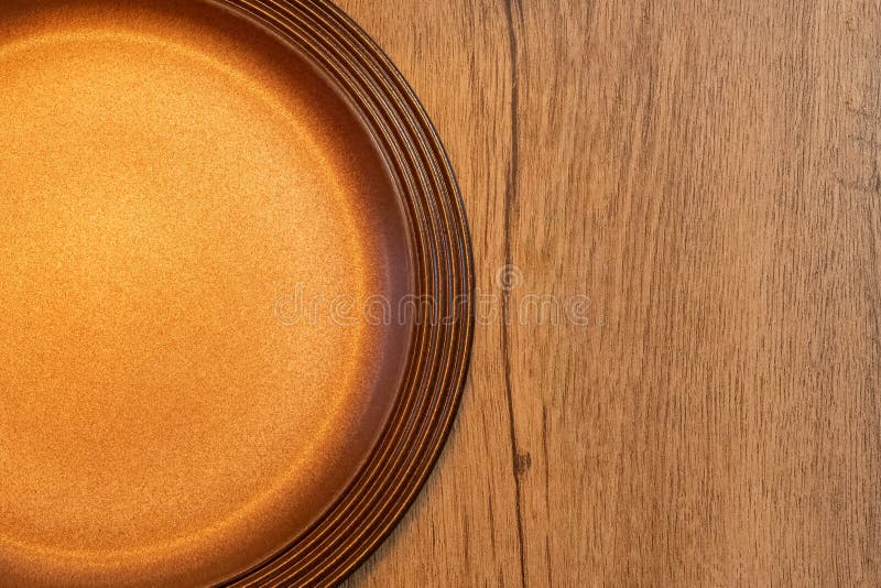 Top view part of empty brown plate on rustic wooden table copy space for text royalty free stock photography