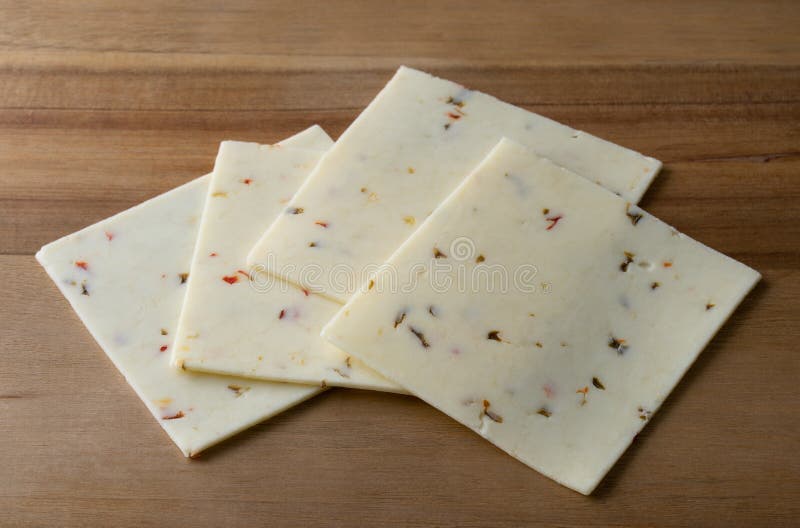 Pepperjack Cheese Slices on a Cutting Board Stock Image Image of