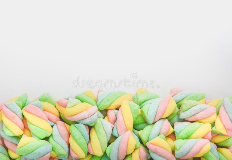 Top view pile of twisted pastel color marshmallow on white background, copy space