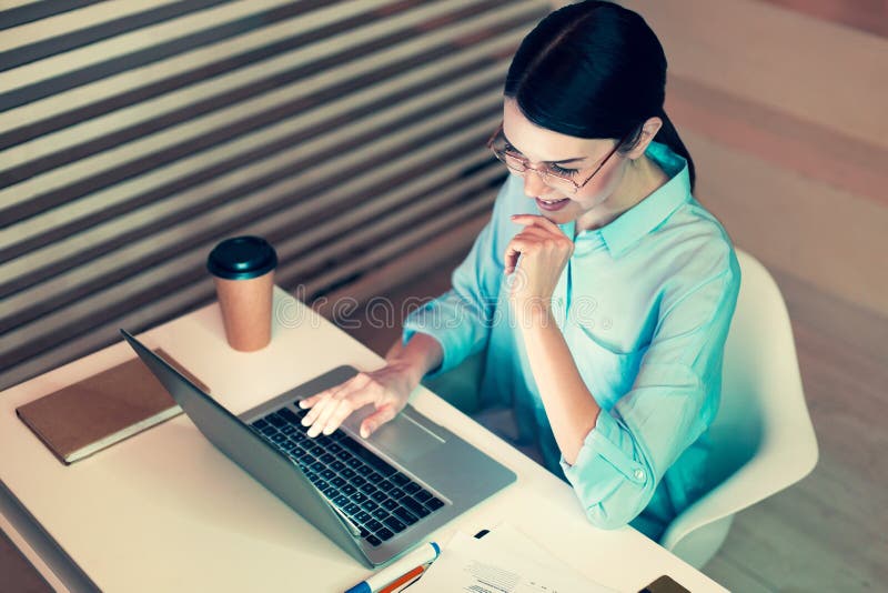 Top view of pleasant woman proofreading her report