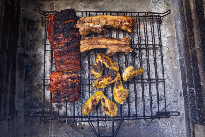 Top View of Pork and Chicken Barbecue on Wire Rack on a Grill Stock