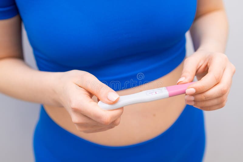 Top View on Positive Pregnancy Test in Woman Hands Stock Photo Image