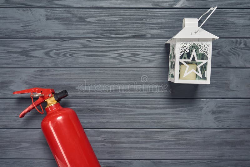 Fire extinguisher and candle lantern on wooden planks royalty free stock photography Fire extinguisher and candle lantern on wooden planks royalty free stock photography
