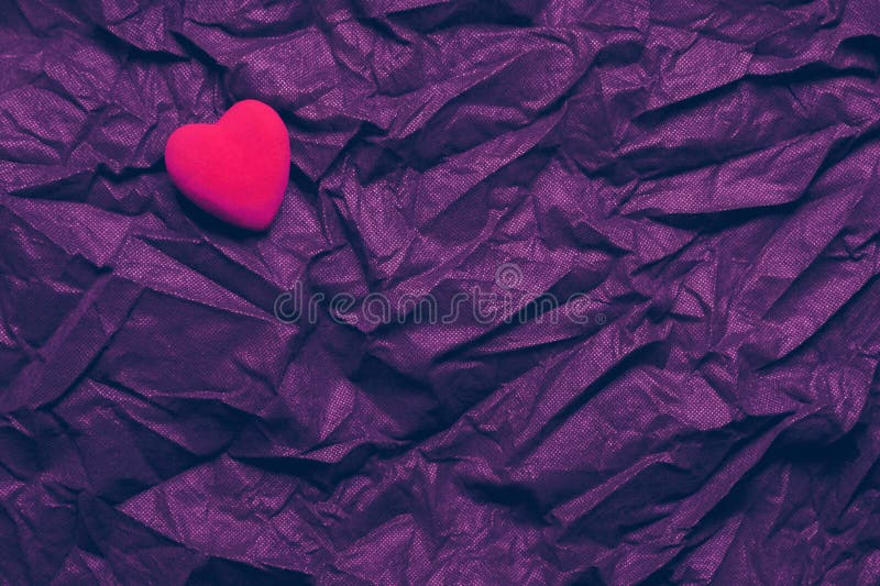 Top View Red Heart On Wrinkled Dark Purple Texture Background. Happy Valentine`s Day And Love Concept. Romantic Card, Banner