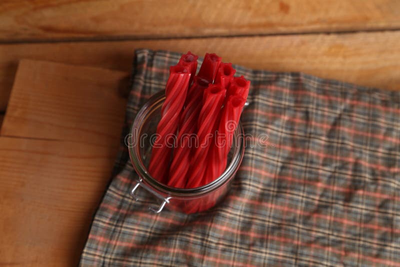 Top View of Red Licorice Candy Pieces in a Glass Jar on a Kitchen Table