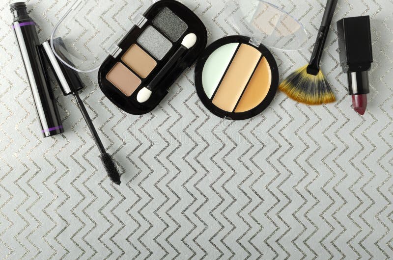 Top view of decorative cosmetica on the grey wrapping paper.Empty space